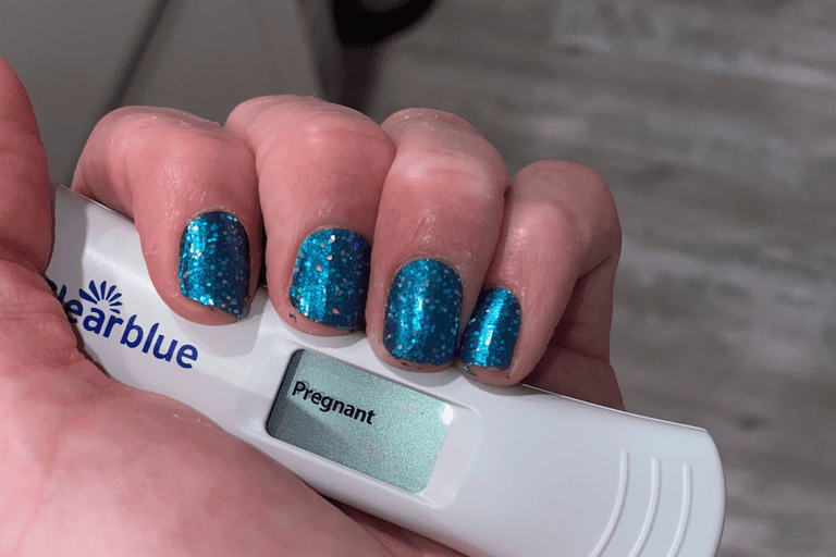 Woman holding pregnancy test