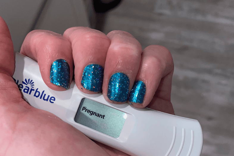 Woman holding pregnancy test