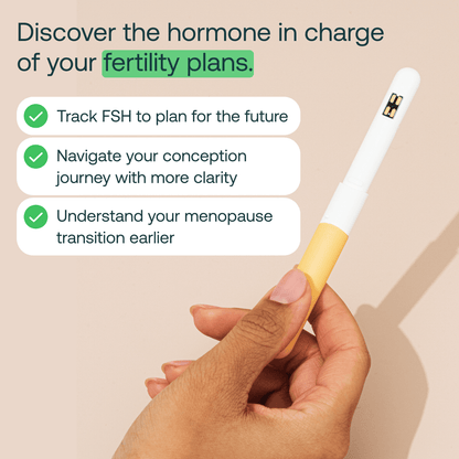 Hand holding Mira FSH fertility hormone tracking wand with benefits for conception planning and menopause transition