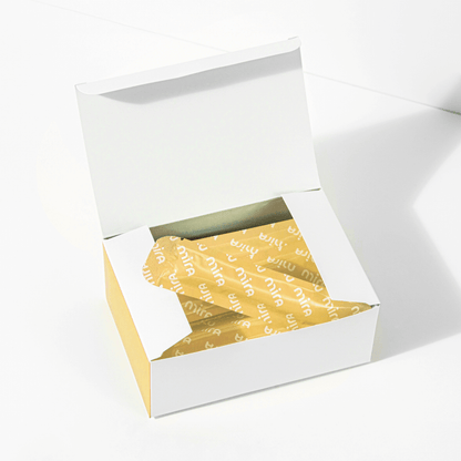 Mira Fertility open white box revealing gold foil-wrapped wand test strips inside