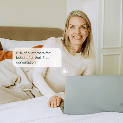 Woman smiling on bed with laptop during online fertility health consultation, 91% of customers felt better after first consultation
