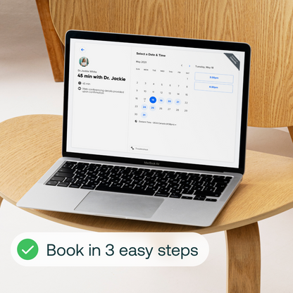 Laptop displaying a telehealth appointment booking interface with calendar and time selection for a 45-minute consultation.