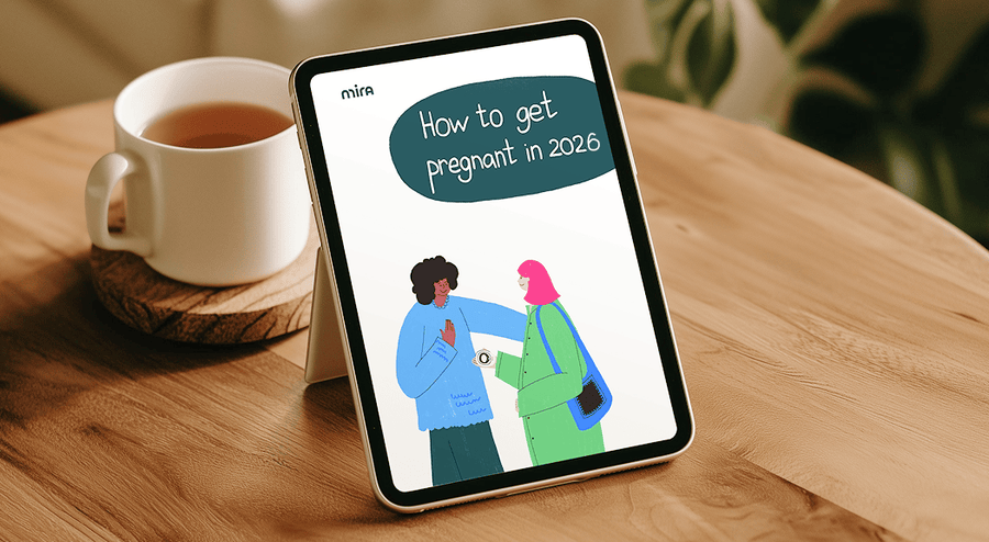 Mira Fertility guide "How to Get Pregnant in 2026" displayed on a tablet beside a warm cup of tea