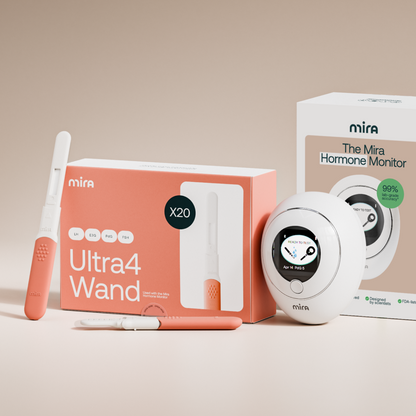 Mira Ultra4 Wand kit with white and coral components, including two circular monitoring devices and test strips on beige back