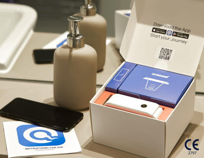 ExSeed Sperm 2 Test Kit contents displayed in open white box with blue device, orange accessories, instruction card, and QR c